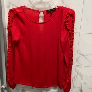 red shirt with ruffles on sleeve